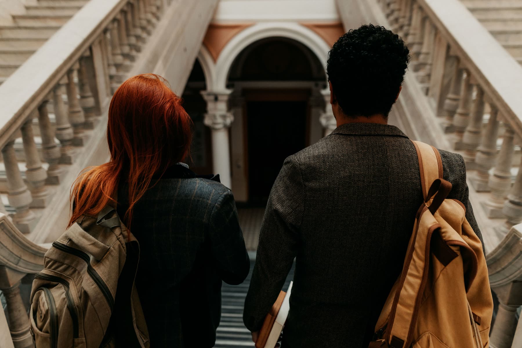 Students walking down a grand university staircase